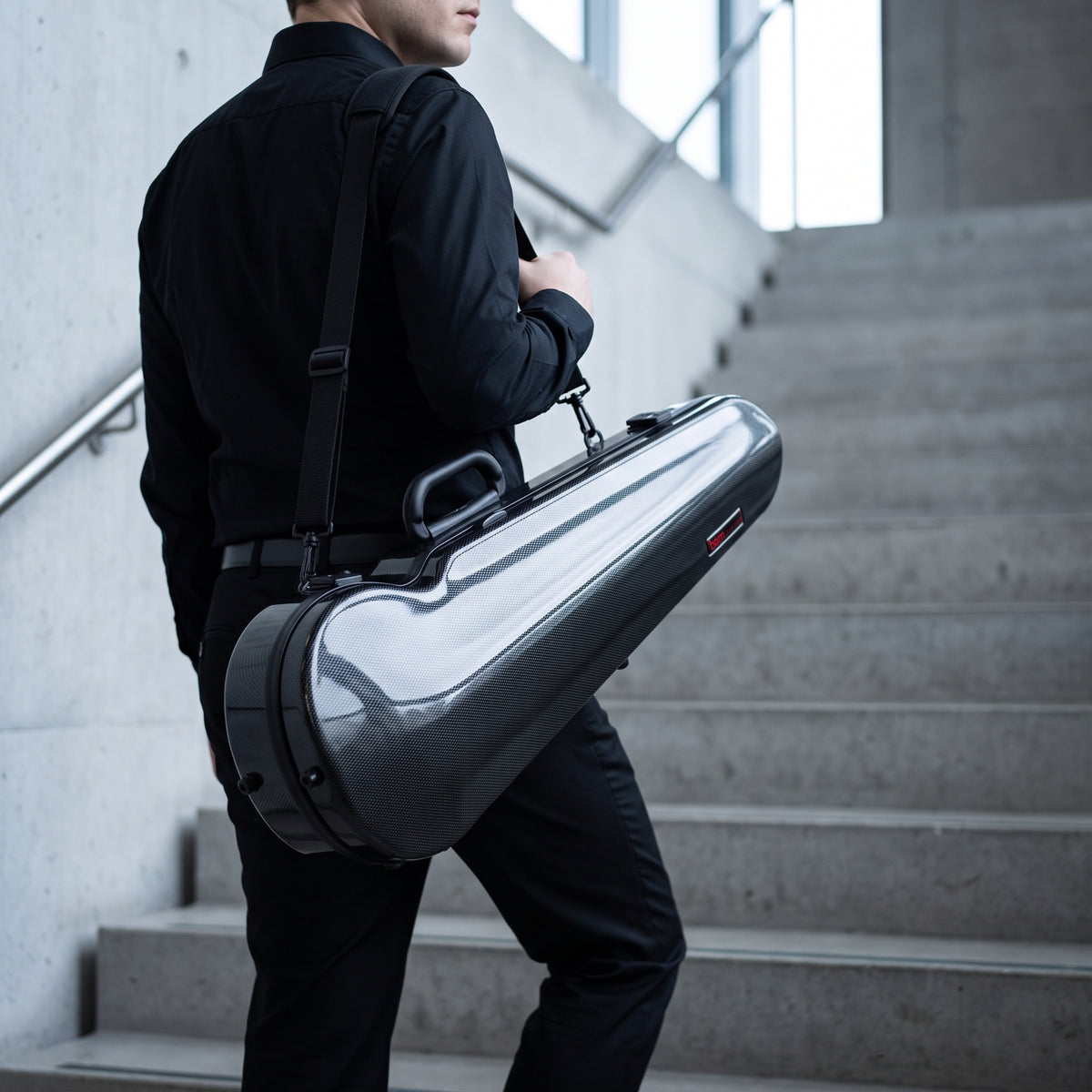 Bam Hightech Contoured violin case, carbon black, carried in a stairwell